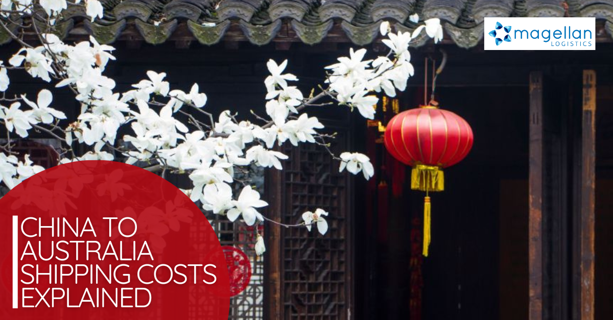 China to Australia shipping costs: Close up of white blossom and a red chinese lantern in front of a dark building.